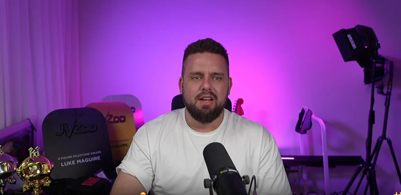 Luke at the microphone in his purple-lit home studio