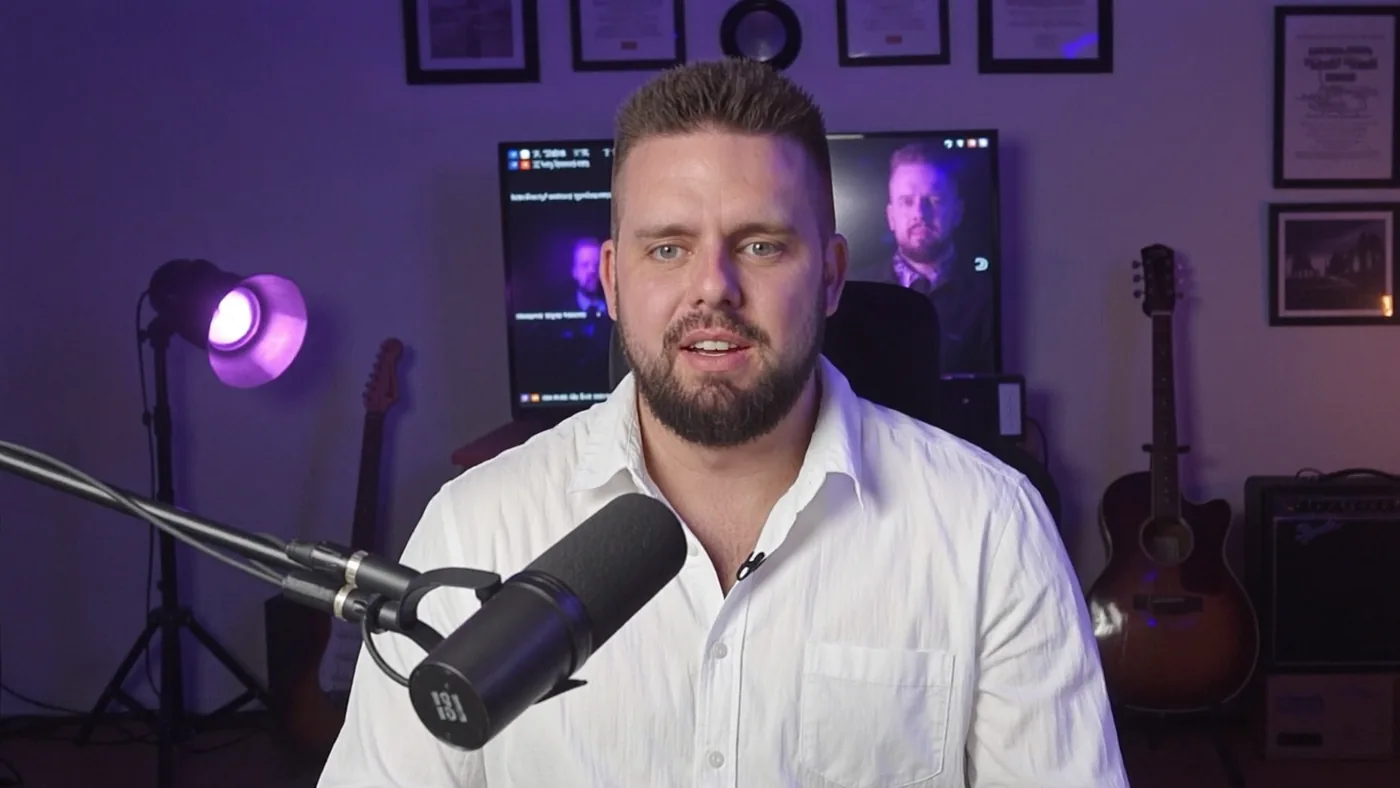 Luke Maguire at the microphone in his purple-lit studio